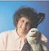 Photo of Fran Friedman with guitar and hand puppet links to her website