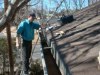 Tim scrubs out rust and stubborn debris preparing for rust reformer treatment of rain gutters. 