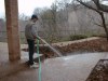 Tim washes down the patios and sidewalks during the precleaning stage of the window cleaning project.
