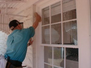 Shaun give the glass, frames and proximities a thorough scrub in the the presoak phase of cleaning this French window.