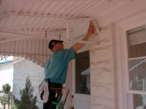 Shaun washes down the dusty proximities of the windows in the precleaning phase of this window cleaning project.