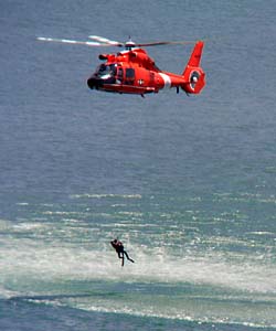 [Photo of helicopter performing sea rescue demonstration]